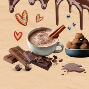 Mug holding coffee surrounded by chocolate themed items like a chocolate bar, truffles, and a chocolate drip coming down from the top of the image. There are hearts and little stars around the coffee.